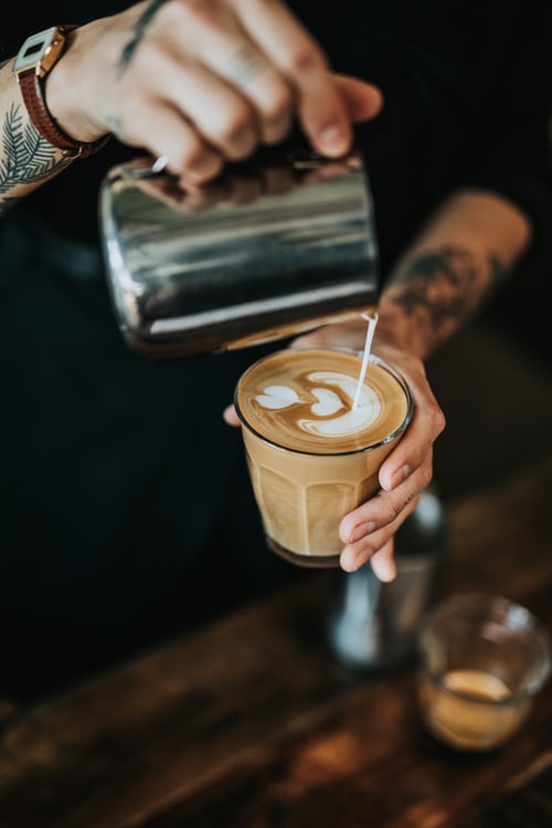 barista pouring milk